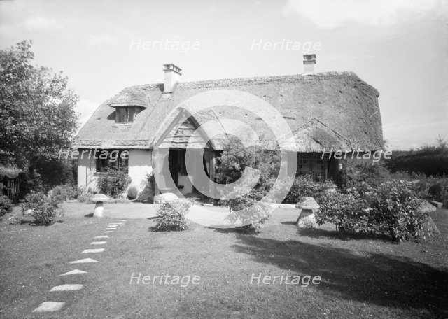 Thatched cottage and garden, c1935. Creator: Kirk & Sons of Cowes.