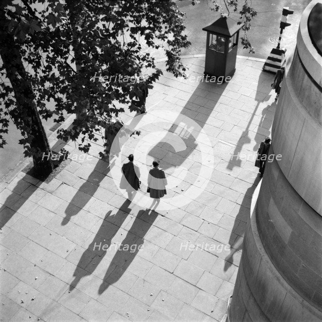 Pedestrians on the Victoria Embankment, London, seen from Waterloo Bridge. Artist: SW Rawlings