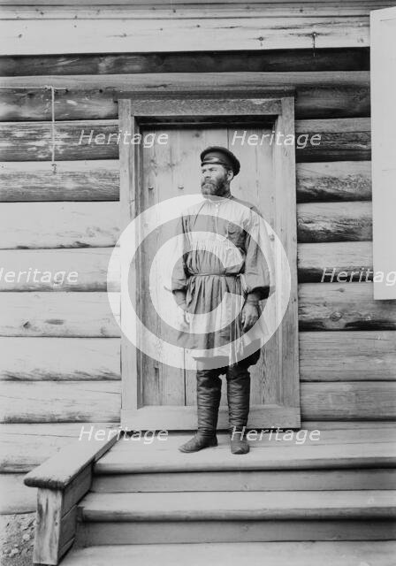 Portrait of an unknown man on the porch of a wooden house, 1900. Creators: I. A. Podgorbunskii, V. I. Podgorbunskii.
