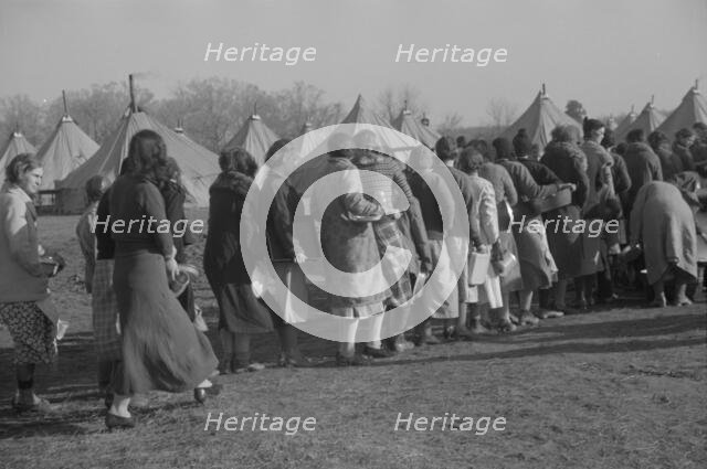 Refugees lined up at meal time in the camp for white flood refugees in Forest City, Arkansas, 1937. Creator: Walker Evans.