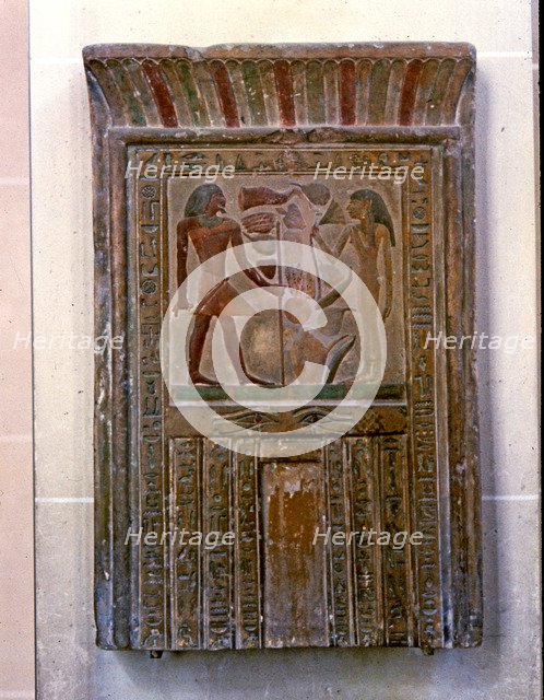 Door shaped stela representing Senouret and his wife in front of their offerings, made in polychr…