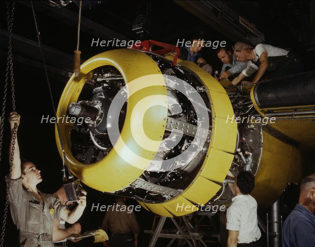 Mounting motor on a Fairfax B-25 bomber, North American Aviation, Inc., Inglewood, Calif., 1942. Creator: Alfred T Palmer.