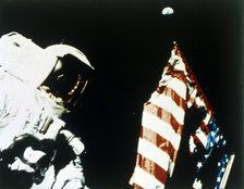 Harrison Schmitt with US flag on the surface of the Moon, Apollo 17 mission, December 1972. Creator: NASA.