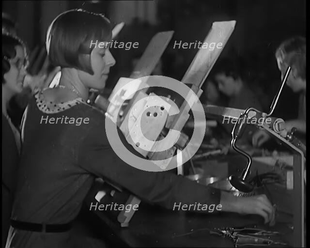 Female Civilians Working on a Factory Production Line, 1931. Creator: British Pathe Ltd.