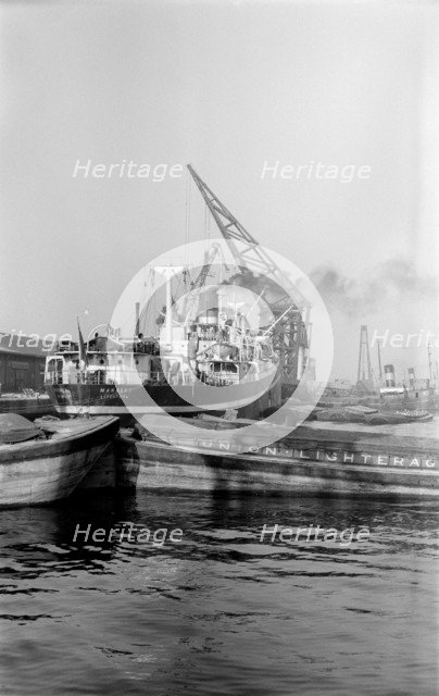 A crane unloading cargo from the 'Makalla' in Tilbury Docks, Essex, c1945-c1965. Artist: SW Rawlings