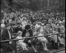 British People Watching Chimpanzees Having a Tea Party at the Zoo, 1940. Creator: British Pathe Ltd.