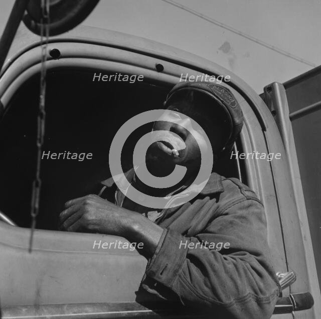 Truck driver for the Alaska Coal Company, Washington, D.C., 1942. Creator: Gordon Parks.