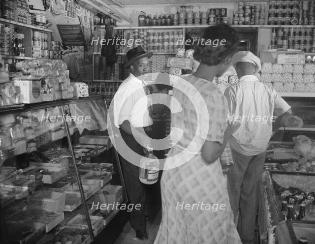 Interior of the grocery store patronized by Mrs. Ella Watson..., Washington, D.C., 1942. Creator: Gordon Parks.