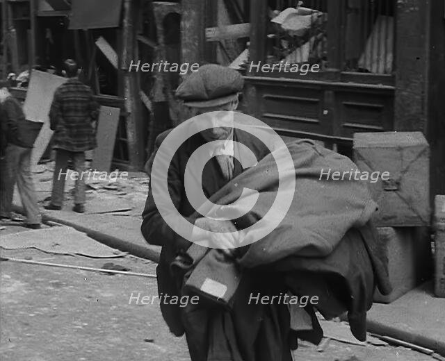 A Man Carrying His Possessions Away, 1940. Creator: British Pathe Ltd.