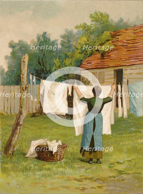 Woman hanging up washing, late 19th-early 20th century? Creator: Unknown.