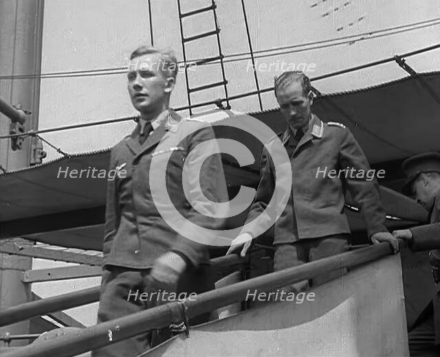 Two Captured German Pilots Being Escorted Down a Gangplank, 1940. Creator: British Pathe Ltd.