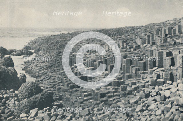 'Tessellated Promenade of the Grand Causeway Laid Down in Lava in the Far Distant Past', c1935. Artists: Unknown, W Lawrence.