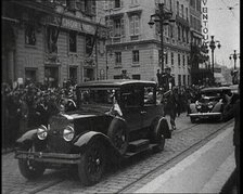 Cars Driving Down a Road, Watched by a Crowd, 1934. Creator: British Pathe Ltd.