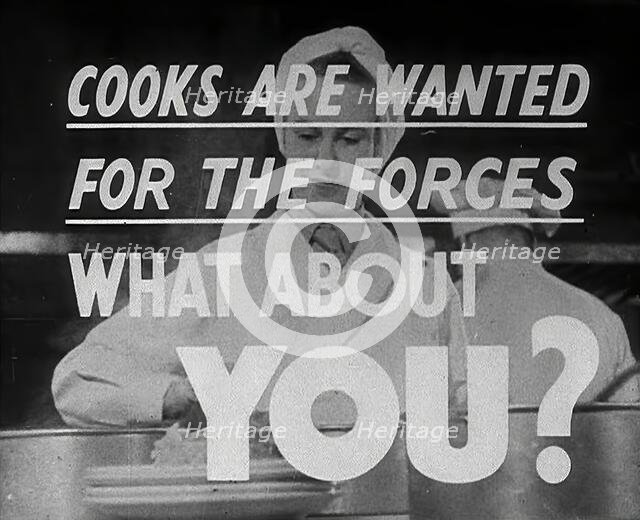 Two Cooks With a Recruitment Slogan on the Screen, 1942. Creator: British Pathe Ltd.