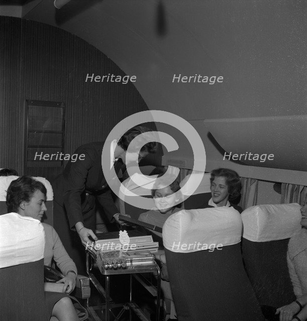 SAS stewardess serving on a flight, 1960. Artist: Torkel Lindeberg