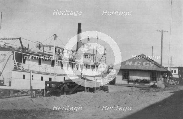 Boat docked at N.C. Co., between c1900 and 1916. Creator: Unknown.