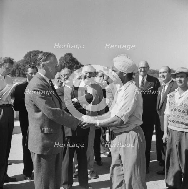 Harold Watkinson, shaking hands with labourer J. Singh, during a visit.., 07/09/1959. Creator: John Laing plc.