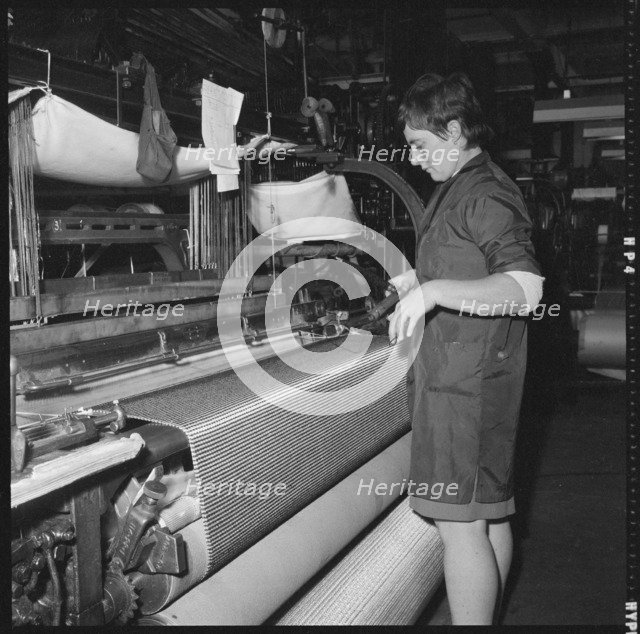 Weaver preparing a shuttle for use in a power loom, 1966-1974. Creator: Eileen Deste.