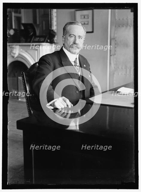 John Skelton Williams at desk, between 1913 and 1918. Creator: Harris & Ewing.