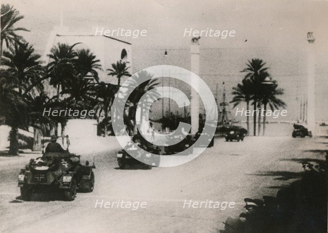 German armoured cars of a Panzer unit drive through Tripolie, West Libya, c.1943.. Artist: Unknown