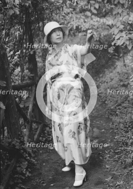 Stettheimer, Florine, Miss, standing outdoors, 1931 Aug. 19. Creator: Arnold Genthe.