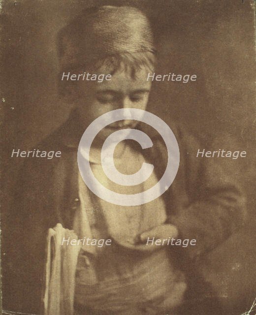 Newsboy looking at coins in his hand, half-length portrait, c1900. Creator: Elizabeth B. Brownell.
