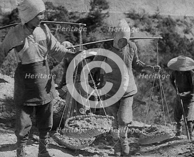Civilians Carrying Supplies Along the Ledo or  Burma Road, 1943. Creator: British Pathe Ltd.