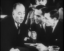 Bruno Richard Hauptmann Talking To His Attorney Edward J. Reilly in a Courtroom During His..., 1930s Creator: British Pathe Ltd.