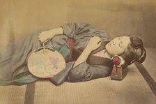 Sleeping Japanese woman holding a fan, 1868-1880. Creator: Felice Beato.