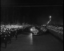 Nazi Party Staff Cars Driving Down a Wide Road in Berlin Edged With...Soldiers..., 1937 Creator: British Pathe Ltd.