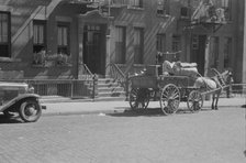 A tenant is moving on horse-drawn wagon, 61st Street between 1st and 3rd Avenues, New York, 1938. Creator: Walker Evans.