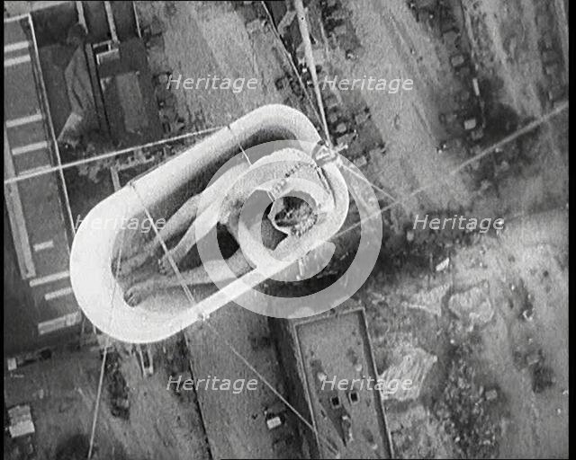 A Male Civilian Sitting in a Bath Lifted Off the Ground By a Hot Air..., 1920s. Creator: British Pathe Ltd.