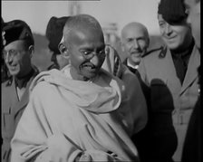 Mahatma Gandhi Standing with Others, 1930s. Creator: British Pathe Ltd.