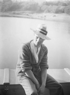 Unidentified man, seated in front of water, between 1896 and 1942. Creator: Arnold Genthe.