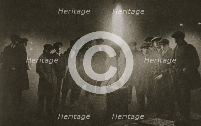 Gathering around an acetylene flare at a traffic control point in the fog, early 20th century. Artist: Unknown