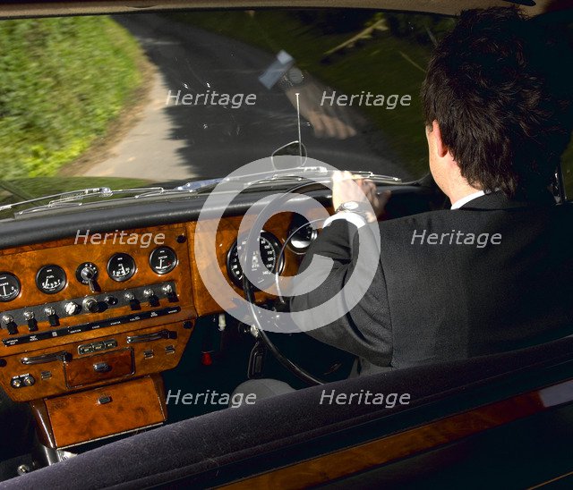 Chauffeur driving 1970 Daimler vanden plas DS 420 limousine. Artist: Unknown.